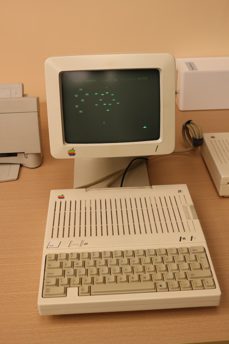An old computer sitting on top of a wooden desk